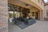 Elegant outdoor patio featuring modern seating, stylish stone wall accents, and lush greenery, perfect for entertaining and relaxation.