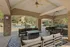Inviting outdoor lounge area with comfortable seating, stylish rugs, and an elegant pool backdrop.