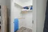 Spacious walk-in closet with modern shelving, ample hanging space, and sleek wood flooring, perfect for organized living.