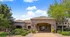Charming apartment entrance with elegant stone accents and lush greenery, inviting you to explore a serene living space.