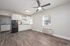 Bright and open kitchen with sleek cabinetry, modern flooring, and a ceiling fan.
