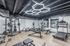 Modern gym with various exercise equipment and sleek lighting, ideal for fitness enthusiasts.
