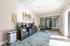 Bright and modern lobby area with stylish furnishings, including a coffee station and artistic wall decor.