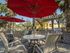 Outdoor grill with table and sitting for outdoor dining.