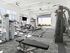 Modern fitness center with state-of-the-art equipment, natural lighting, and spacious layout.