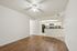 Bright and airy apartment interior with modern kitchen, sleek cabinetry, and elegant wood flooring.