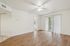 Bright and airy living room with elegant wood flooring and natural light from sliding glass doors.
