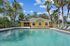 Inviting swimming pool surrounded by palm trees and sun loungers, perfect for relaxation in a tranquil environment.