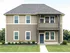 Charming two-story home with a modern facade, featuring elegant windows and a well-maintained front lawn.