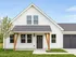 Charming modern farmhouse with a sleek white exterior and inviting front porch, set against a clear blue sky.