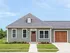Charming single-story home with a welcoming facade, featuring modern siding and a spacious attached garage, ideal for comfortable living.