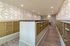 Sleek mailroom with elegant gold mailboxes, modern lighting, and stylish geometric wallpaper design.