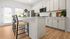 Bright, modern kitchen with sleek cabinetry, stylish barstools, and abundant natural light.