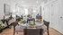 Chic and modern living space with a glass dining table set for four, elegant decor, and ample natural light.