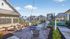 Charming apartment complex courtyard with cozy fire pit, inviting seating area, lush landscaping, and quaint pathways.
