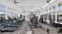Bright and modern fitness center with state-of-the-art equipment, large windows, and stylish layout.