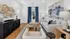 Chic living room showcasing modern decor with abstract wall art, elegant furnishings, and vibrant blue curtains for a stylish ambiance.