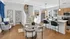 Modern open-concept living area featuring a stylish kitchen, elegant dining space, and cozy seating with natural light streaming through large windows.