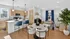 Chic open-concept apartment with a modern kitchen, elegant dining area, and cozy living space adorned with vibrant greenery and natural light.