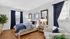 Chic and cozy bedroom featuring elegant decor, plush bedding, and abundant natural light with stylish blue accents.