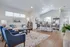 Elegant open-concept living space with a cozy seating area, stylish kitchen, and modern decor, perfect for comfortable living.