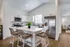 Elegant modern kitchen with sleek white cabinetry, stainless steel appliances, and an inviting island with stylish seating.