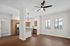 Bright and modern open-concept kitchen and living area with sleek wooden cabinets, stainless steel appliances, and elegant lighting. Perfect for entertaining and relaxation.