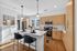 Contemporary kitchen with sleek wooden cabinets, stainless steel appliances, and a bright, airy open layout featuring a stylish breakfast bar.