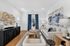 Contemporary living room with elegant decor, featuring a plush white sofa, abstract wall art, and a stylish wooden coffee table, accented by blue curtains and a modern sideboard.