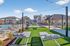 Inviting outdoor pool area with sleek lounge chairs and modern pergolas, surrounded by lush landscaping and contemporary architecture.