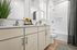 Elegant bathroom with modern cabinetry, stylish fixtures, and a relaxing bathtub featuring tasteful decor and a fresh ambiance.