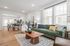 Modern open-concept living area with a stylish green sofa, chic dining space, and abundant natural light.