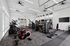 Contemporary fitness center with cutting-edge cardio machines, weight stations, and ample natural lighting.