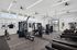 Modern fitness center with top-of-the-line equipment, large windows, and sleek design, perfect for an energizing workout.
