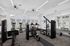 Bright and modern fitness center with state-of-the-art exercise equipment and large windows for natural light.