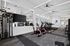 Modern fitness center with state-of-the-art equipment, including treadmills, exercise bikes, and strength training machines, in a bright and spacious setting.
