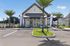 Charming leasing office with modern design, palm trees, and welcoming entry, ideal for luxury rentals.