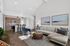 Modern open-plan living area with stylish kitchen, comfortable seating, and elegant decor, perfect for relaxation and entertaining.