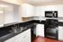 Modern Kitchen with white cabinetry and black appliances and countertops  | Wabash Landing | Apartments in West Lafayette