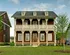 Beautiful two-story suburban house with a welcoming porch and manicured front lawn.