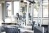 Spacious and well-lit fitness center equipped with modern gym equipment and large windows.