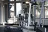 Bright, modern gym with exercise equipment and large windows overlooking a green courtyard.