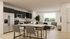 Stylish open-concept kitchen and living room with natural lighting.