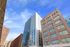 Stunning urban apartment buildings with modern architecture against a bright blue sky.