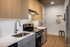 Sleek modern kitchen with high-end stainless steel appliances, elegant wood cabinetry, and polished countertops offering a stylish cooking experience.