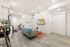 Modern open-concept living area with elegant decor, cozy seating, and a stylish kitchen in a bright and inviting apartment space.