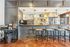 Chic caf&eacute;-style kitchen with stylish bar stools, pendant lighting, and a modern coffee station.