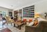 Inviting communal lounge with cozy seating, large calendar wall, and chessboard, perfect for relaxation and social gatherings.