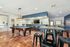 Chic recreation room featuring a modern pool table, elegant lighting, and a stylish bar area with sleek seating.