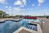 Luxurious swimming pool area with red lounge chairs and picturesque sky, perfect for relaxation.